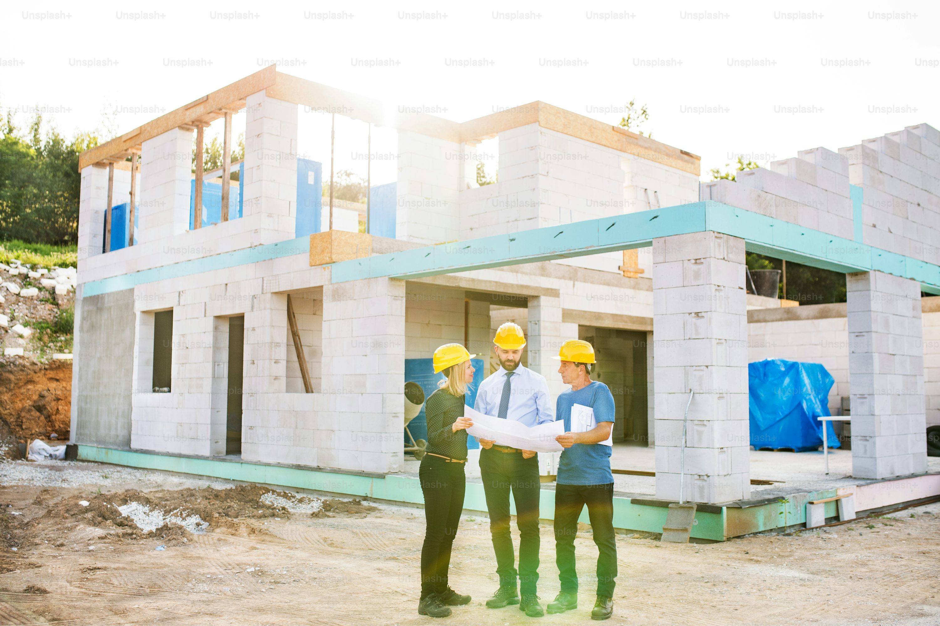 Professional architectural drafting services in Mobile Alabama - construction professionals reviewing detailed blueprints and CAD drawings for residential and commercial projects